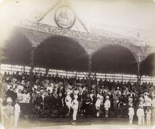 Spectators and dignitaries under a pavilion during the commemoration of Queen Victoria's Diamond Jubilee, Hong Kong, 1897