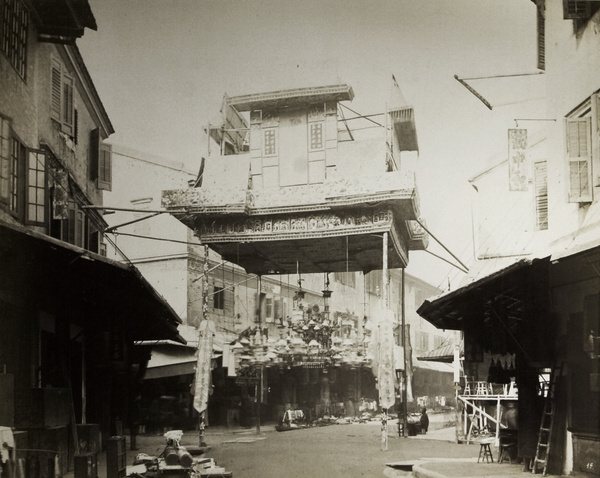 Close view of a decorative gateway on a Chinese street (possibly Queen's Road), Hong Kong, 1869