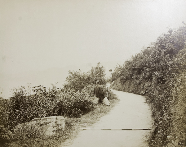 A Chinese man sitting by the roadside, Hong Kong