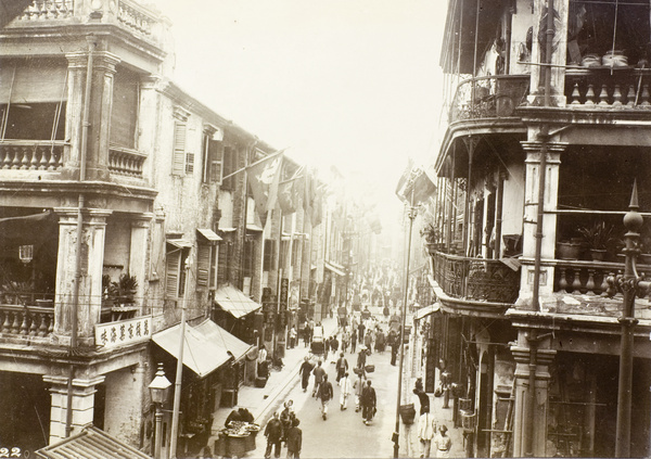 Busy street scene, decorated with flags, Hong Kong