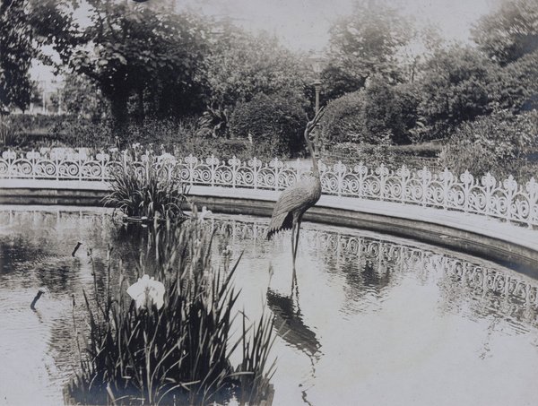 Bronze crane in a pond in a park