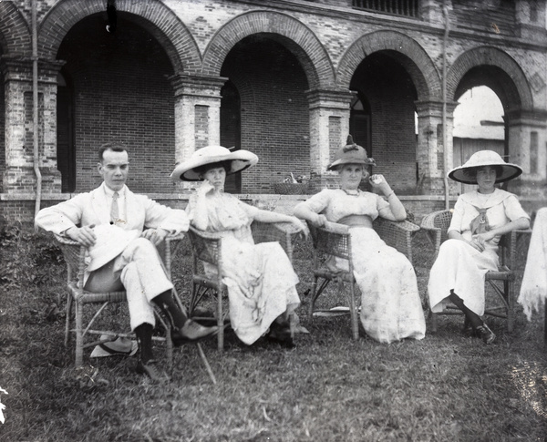 A man and three women in a garden