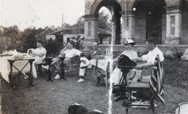 Oliver Heywood Hulme with a group at a garden party