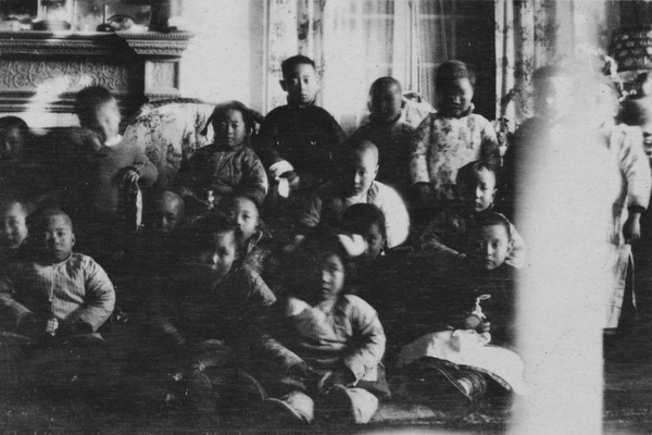 A group of Chinese children in a sitting room