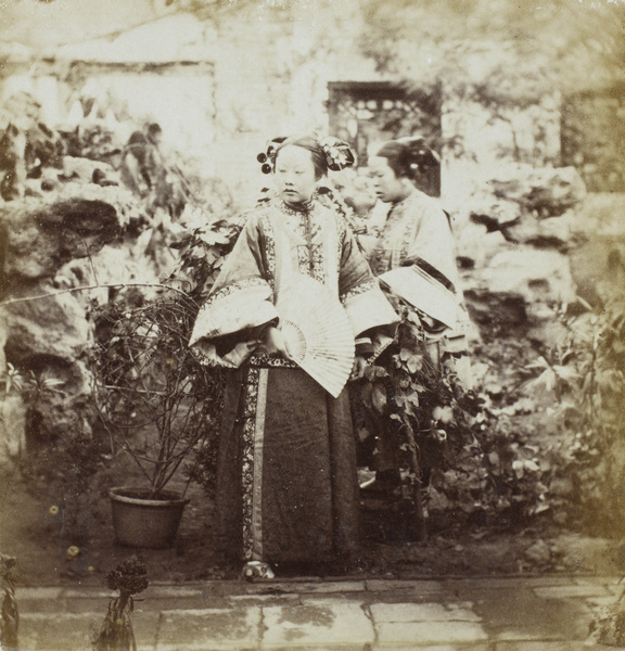 A Manchu woman with her maid, in a rock garden (one of Yang Fang's courtyards), Beijing