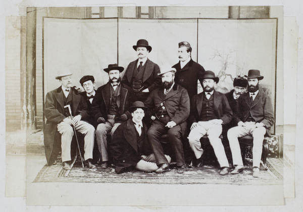 A group of ten men in front of a screen