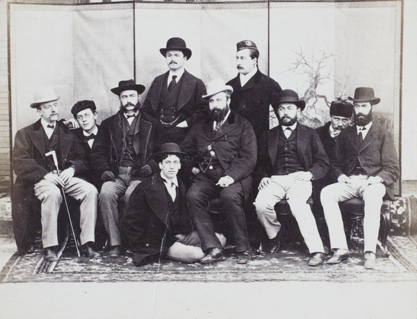 A group of ten men in front of a screen