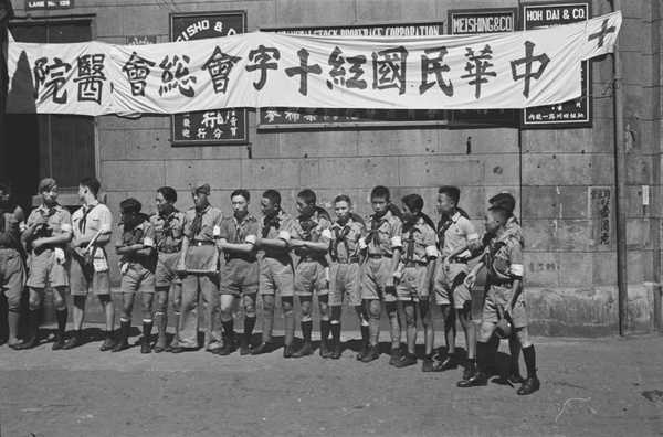 Chinese Boy Scouts outside Shanghai Stock Brokerage Corporation office (serving as a Red Cross hospital), Shanghai
