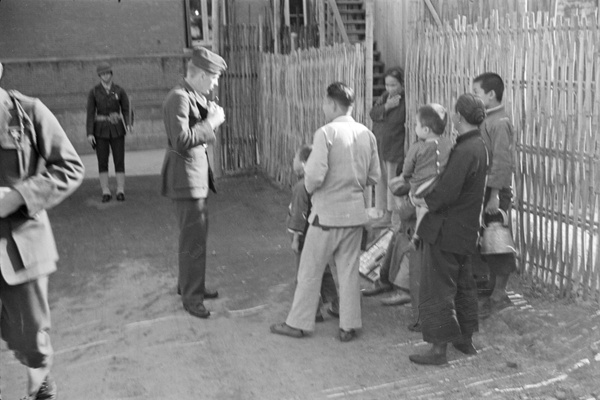 Street seller, onlookers and American marines, Shanghai