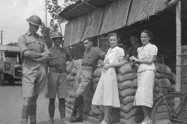 Women chatting with British Army soldiers at a roadside check point, Shanghai