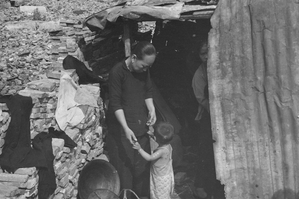 Family in temporary shelter in bombed district, Shanghai
