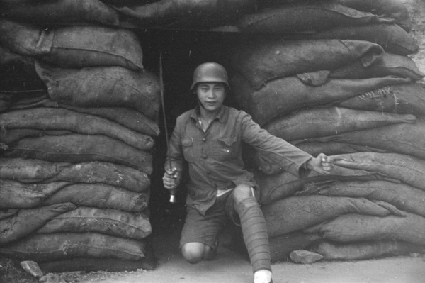 Nationalist soldier posed by sandbags, North Railway Station, Shanghai