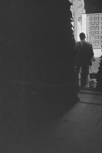 People by sandbagged doorway, Shanghai