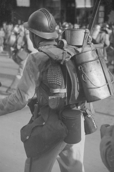 French soldier carrying kit including cooking pots and hobnail boots, Shanghai