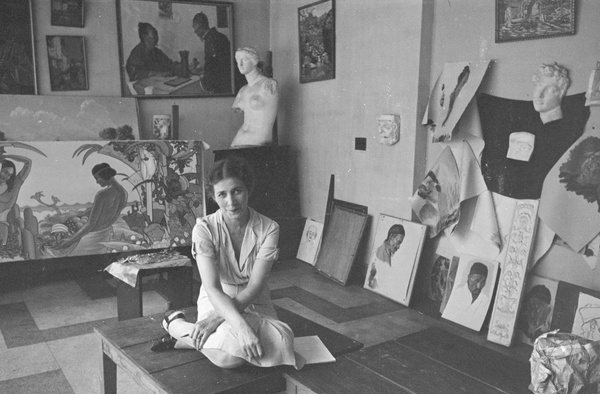 A woman sitting on a table in the studio of Victor Podgoursky, Shanghai