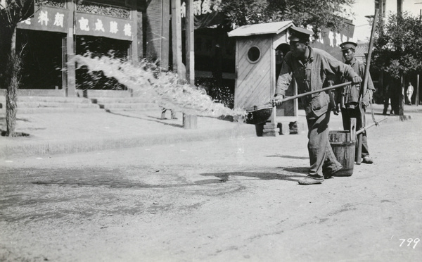 City workers watering a street (dust control), Peking