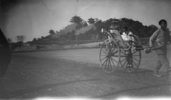 A rickshaw in Peking, Coal Hill in the background