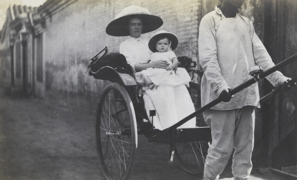 Mother and child in a rickshaw, Rotting Vegetable Street, Peking