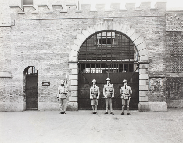 Samson, Wall and Grant, with Sikh prison officer, outside SM Gaol, Shanghai