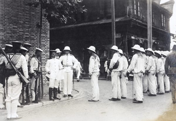 Russian and Japanese Sailors being told to guard the Settlement Boundary, Shanghai, during the Xinhai Revoltion