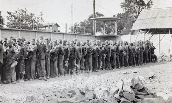 Convicts lined up in a prison stone breaking yard, Shanghai