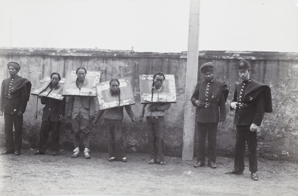 Policemen with four handcuffed prisoners in cangues, Shanghai