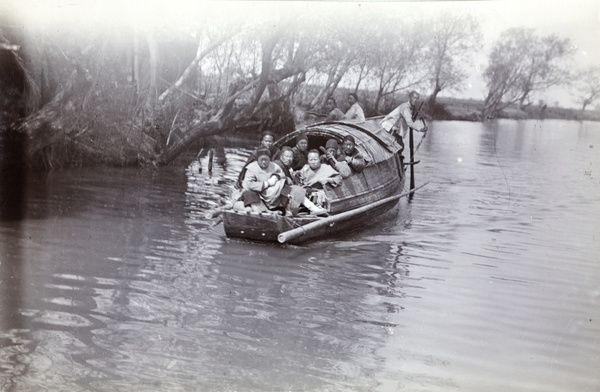 A boat laden with passengers, Suzhou Creek (Wusong River), near Shanghai