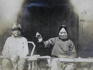 Two girls weaving