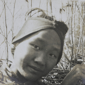 Portrait of a youth wearing a head scarf