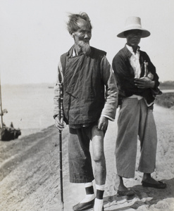Two men next to the river, possibly Hankow (Wuhan)