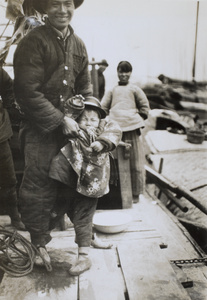 Man, woman and a crying child on board a boat