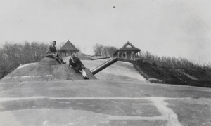 Sitting on top of a cannon of the German fortification of Qingdao