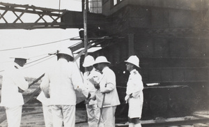 Officers examining plans of the militart base, Singapore