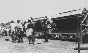 A group of workers next to a few train carts, Singapore