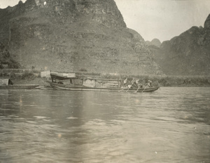 River boat being propelled by poles
