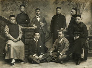 Eight Chinese men in a photographer's studio