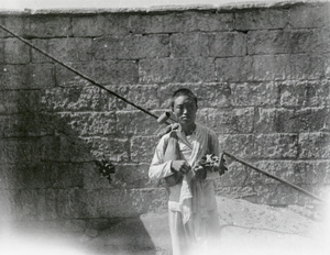 A fisherman, with fishing rod
