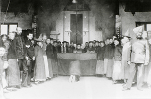 A defendant kneeling in a mixed court room, Shanghai