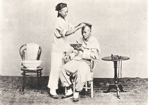 Barber with customer in a photographer's studio, Shanghai