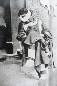 Wounded and blindfolded Kansu soldier, Peking