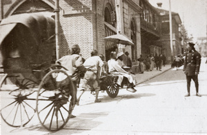 Rickshaw, wheelbarrow and policeman, Nanking Road, Shanghai