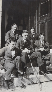 Group of men on a doorstep