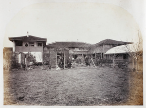 A couple outside a house and garden, with domestic staff