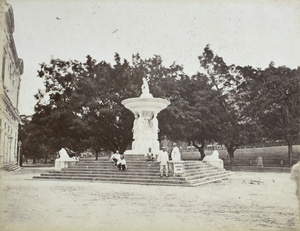 A few people sitting on the steps of Dent's Fountain, Queen's Road Central, Hong Kong