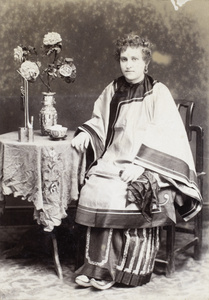 Studio portait of an European woman wearing Manchu style clothing