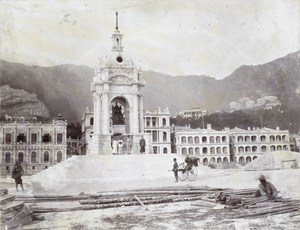 A few Chinese and a Sikh policeman standing in front of Queen Victoria's statue at Statue Square, Hong Kong