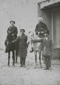 Harold Ivan Harding, with ponies and two men holding the reins, Kashgar