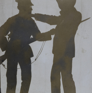 Silhouette of a soldier bayonetting a man