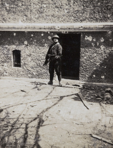 Japanese soldier posing in war damaged area, Shanghai, 1932