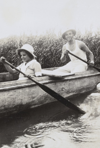 Gladys Ephgrave and E. P. Morphew rowing a boat